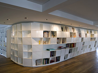 Illustration for article titled Giant Curvalicious Bookshelf Winds Its Way Through Your Apartment